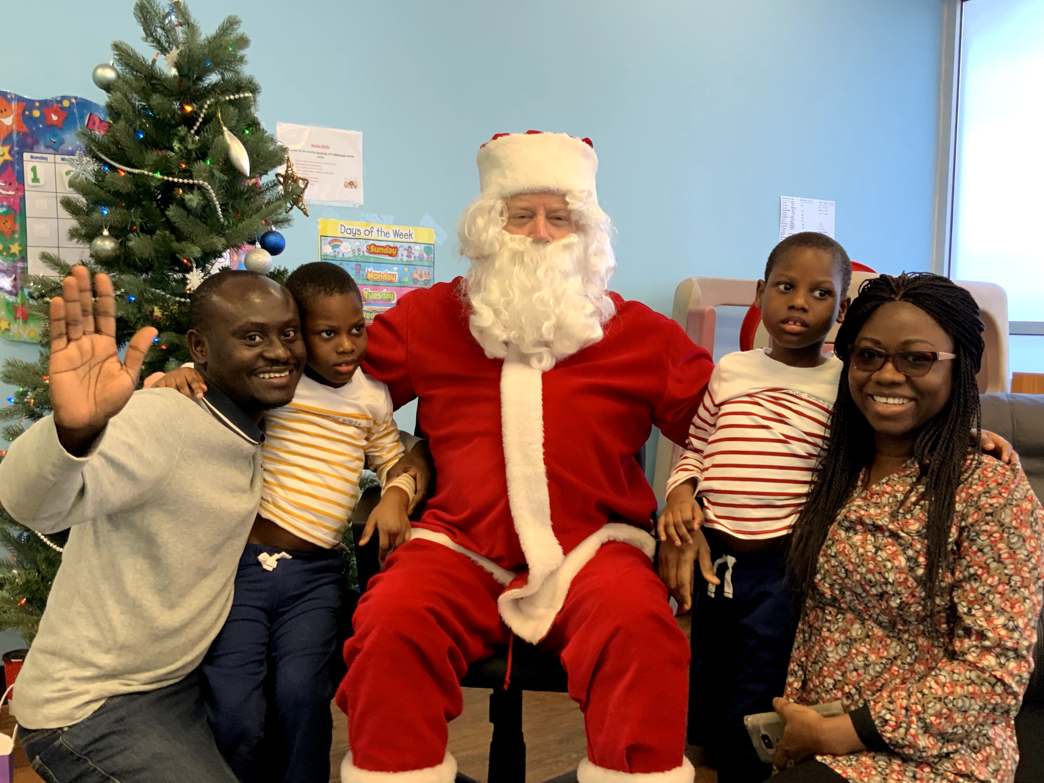 Santa poses with a family of two children