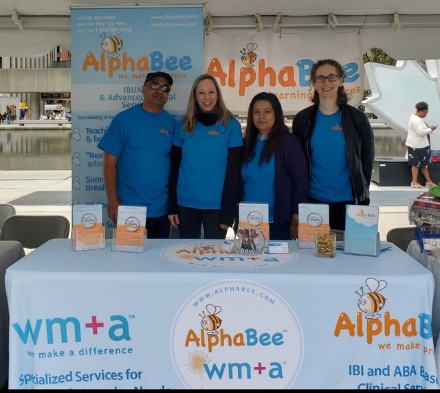 AlphaBee staff in front of a booth at Autism Speaks Canada Walk