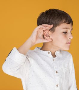 Teaching Children With Autism To Speak - child holding ear out to listen