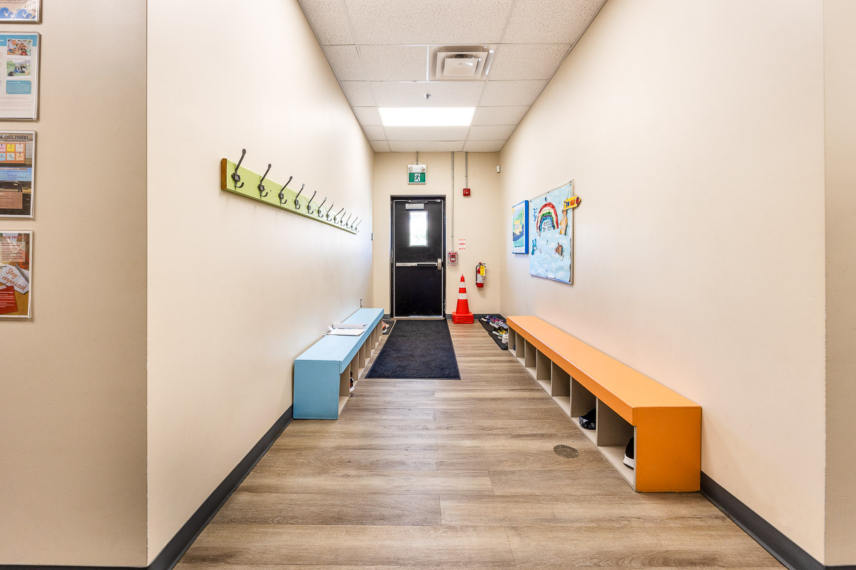 Family entrance hall at AlphaBee's Etobicoke centre, with benches and coat hooks