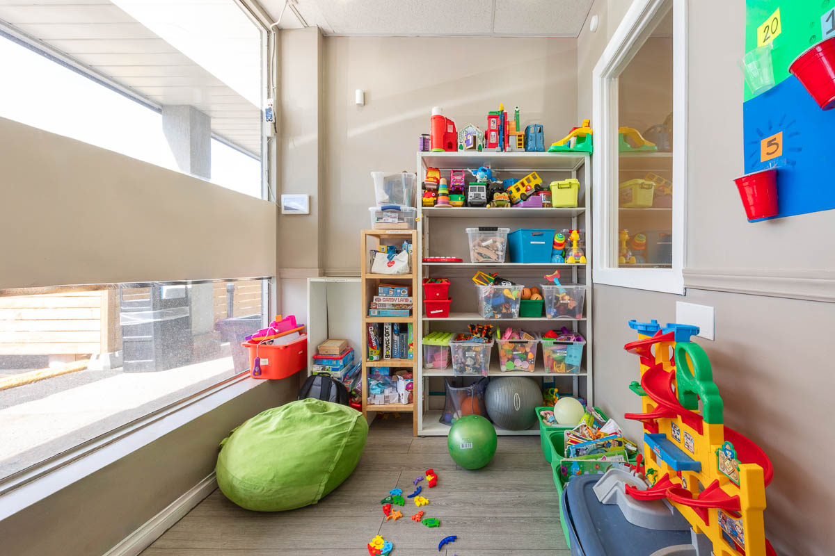 Sunny play room at AlphaBee's Scarborough centre, with shelves of toys and bean bags